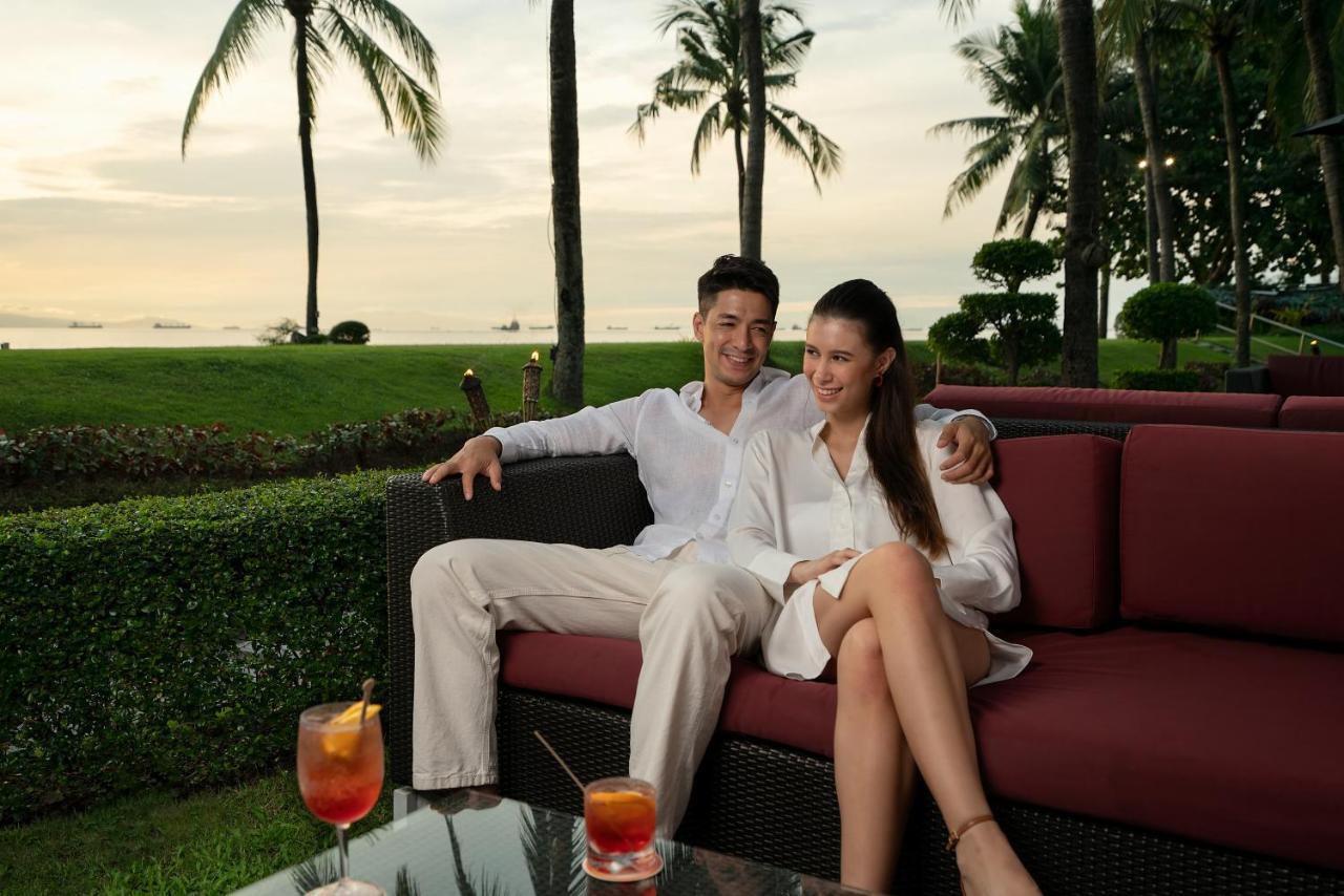 Sofitel Philippine Plaza Manila Hotel Pasay Exterior photo A couple relaxing at the beach