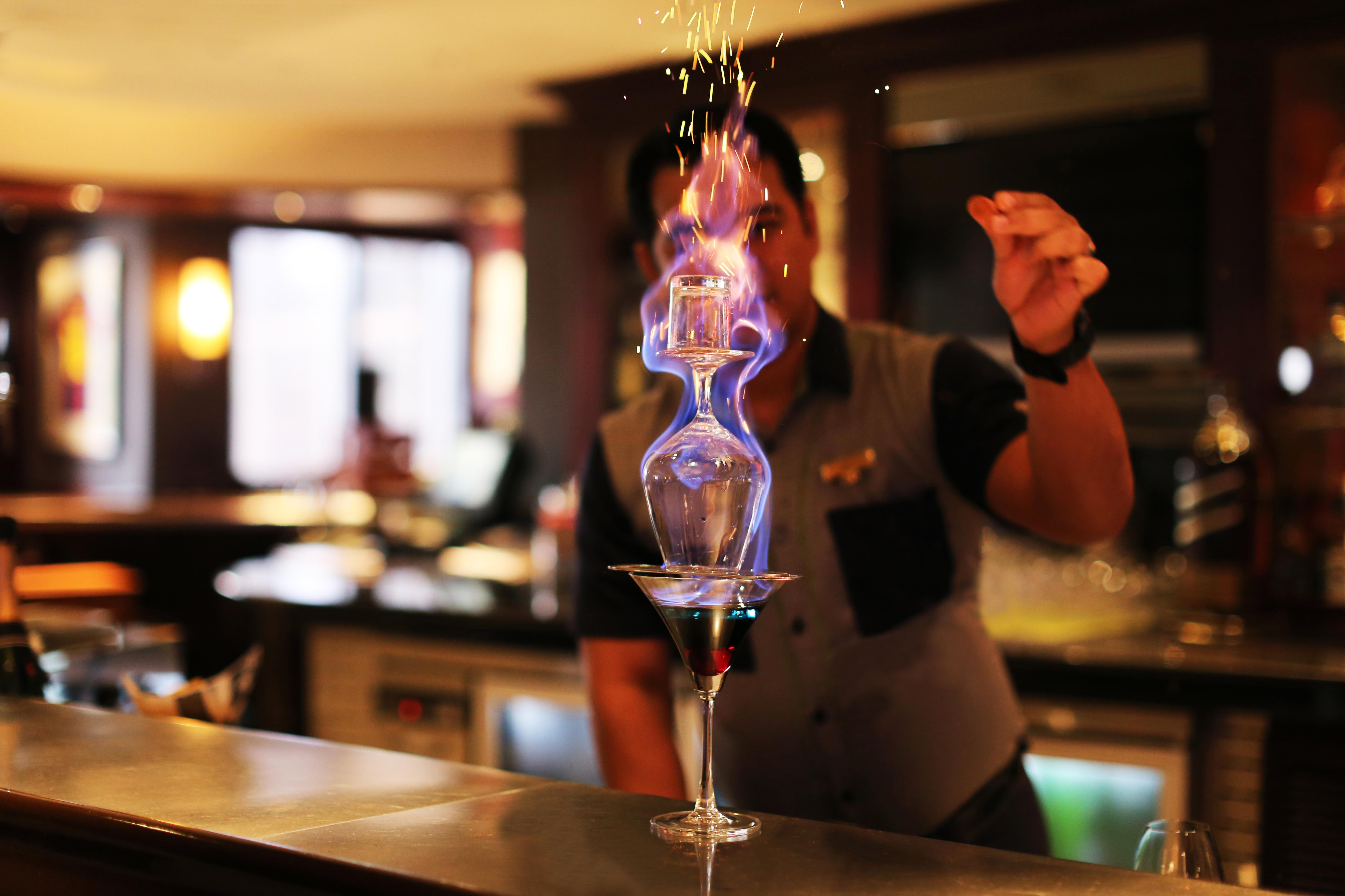 Sofitel Philippine Plaza Manila Hotel Pasay Exterior photo A bartender preparing a flaming cocktail